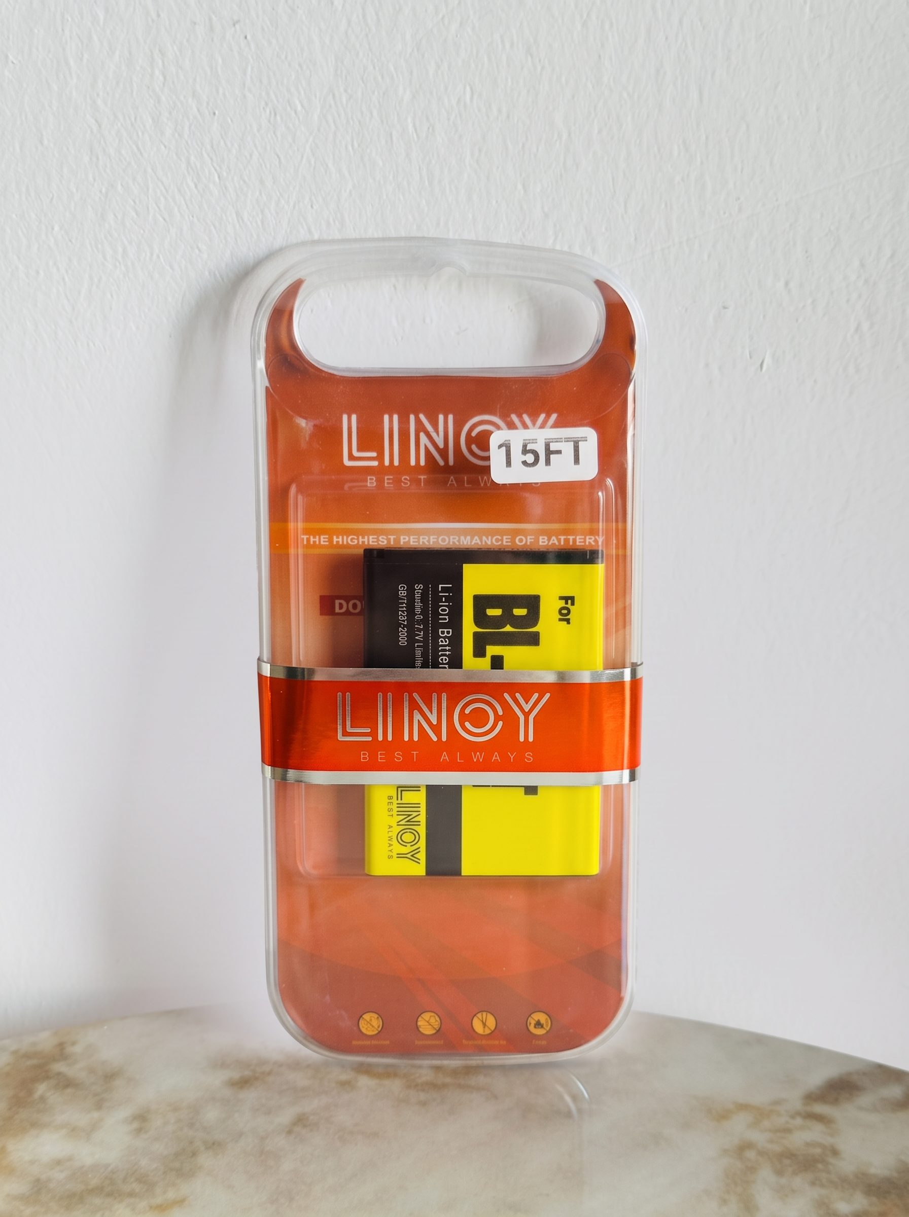 Front view of the LINOY BL-15FT battery in orange retail packaging